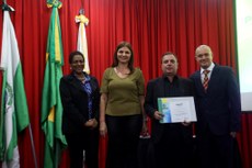 Professor Glauco recebe o prêmio da  pró-reitora de pesquisa, Cláudia; vice-reitora Tangriane; e Marcos Pelegrina.